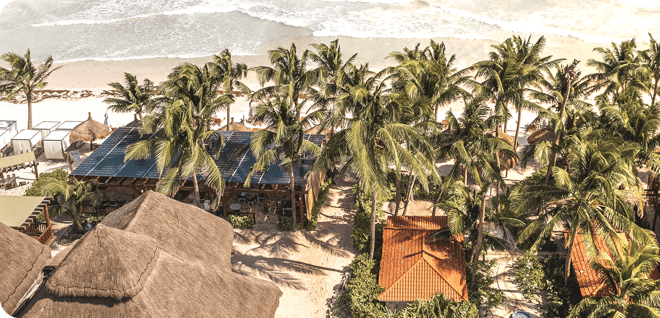 Ana y Jose aerial view of the hotel, palm trees, palapa roofs, Tulum beach, tropical retreat